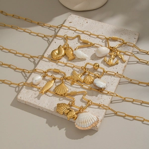 Gold plated titanium steel necklace featuring ocean shell, starfish and pearl pendants