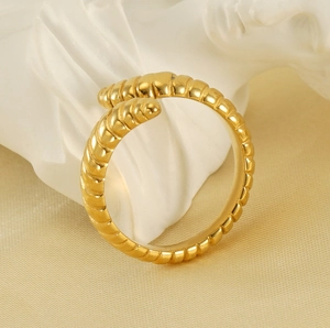 Macro shot of gold croissant dome ring with a spiral twist design on a stone pedestal