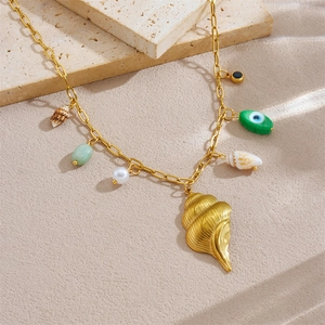 Gold ocean shell necklace with pearls and evil eye beads on a beach theme pendant chain