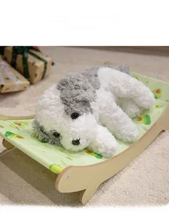 Detail of grey plush dog toy on avocado print pet cot with light wood frame