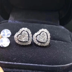 Luxurious heart-shaped diamond stud earrings set in a premium black velvet jewelry box