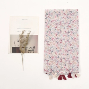 Ethnic style cotton linen scarf with floral print and red fringe tassels on white background