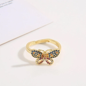 Detailed close-up of a gold butterfly ring with colorful cubic zirconia and open band