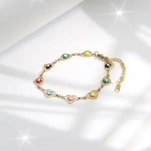 Gold chain bracelet with colorful heart-shaped evil eye charms and adjustable clasp