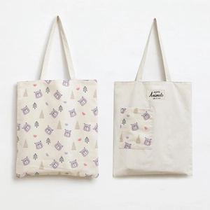 Detail showing two beige canvas tote bags with cute cartoon bear and floral prints