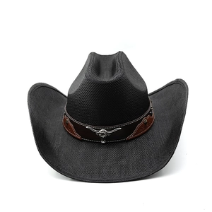Detail of black woven cowboy hat featuring a leather band and silver bull head emblem