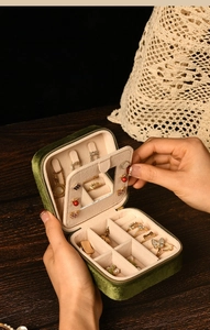 Macro shot of dark green velvet jewelry box with mirror and internal storage slots