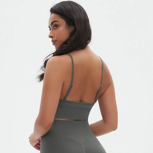 Detail view of adjustable spaghetti straps and high-waisted seamless dark grey yoga set