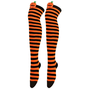 Close-up of Halloween over-knee socks with orange stripes and pumpkin decor
