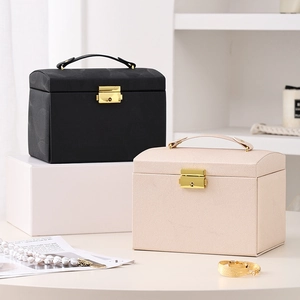 Three-layer leather jewelry box with portable handle and gold metal lock in black and beige