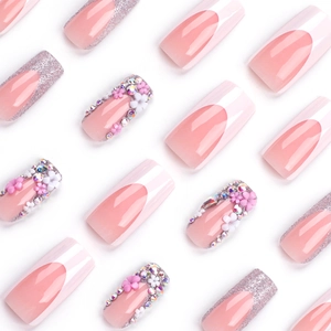 French tip press-on nails with 3D flowers, silver glitter and rhinestones on white background