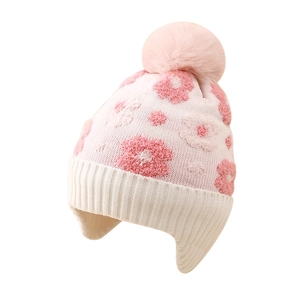 Winter floral knitted hat for girls with earflaps and pink faux fur pompom