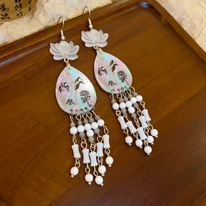 Macro detail of Chinese style lotus earring with pearl tassels and floral pattern