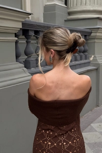 Detail of hollow diamond knit pattern on back of brown off-shoulder maxi dress