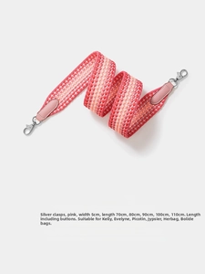 Close-up of pink woven wide shoulder strap with silver clasps and geometric pattern