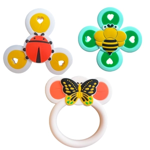 Close-up of three colorful suction cup spinner toys in bee, ladybug, and butterfly shapes