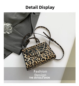Detail of leopard print handbag with metallic buckle and adjustable shoulder strap