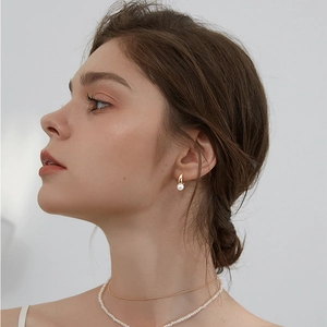 French style pearl drop earrings with gold hoop worn with layered necklaces for women