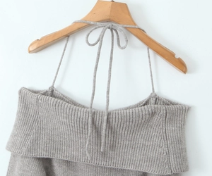 Detail of off-shoulder grey knit mini dress with lace-up string and ribbed texture
