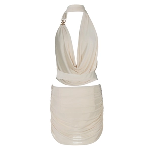 Detail of beige halter top with gold chain and matching ruched mini skirt set