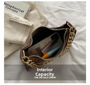 Internal capacity of brown quilted shoulder bag with gold chain showing makeup items