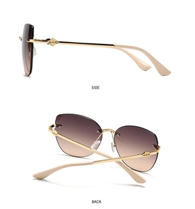 Detail view of gold metal temples with geometric hollow design and gradient lenses