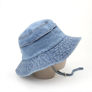 Detail of washed blue denim bucket hat featuring multi-row stitching and adjustable wind rope