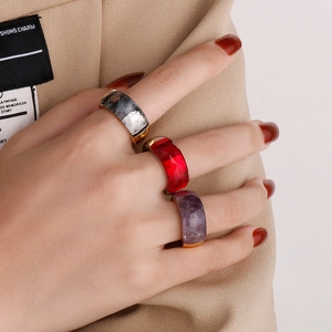 Close-up of vintage gold titanium rings with red, purple, and grey faceted gemstones