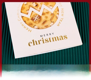 Macro detail of Merry Christmas card with gold foil texture and festive cutout elements