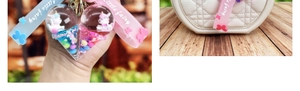 Macro detail of cute liquid oil ice cream keychain with floating unicorn and glitter