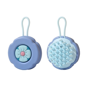 Blue flower silicone shampoo brush with massage bristles and hanging loop on white background