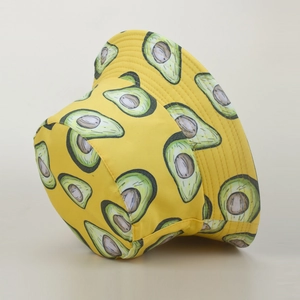 Detail of yellow bucket hat with avocado print made of breathable cotton canvas fabric