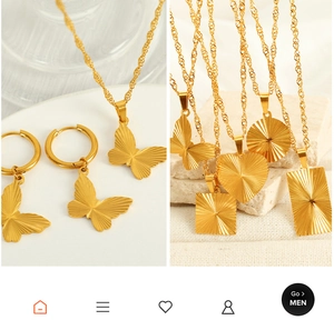 Macro shot of 18K gold plated stainless steel butterfly, heart and round pendant necklaces