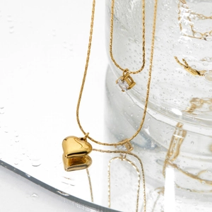 Double-layered 18K gold heart pendant necklace with sparkling white cubic zirconia stones