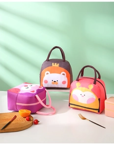 Detailed view of insulated lunch bags with cartoon lion and owl patterns and handles