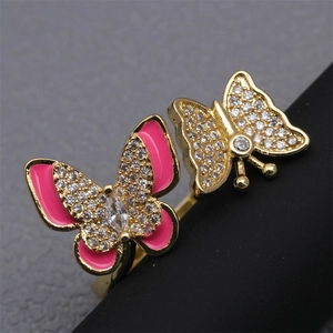 Macro shot of open ring featuring pink enamel butterfly and micro-pave cubic zirconia