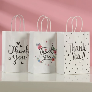 Three assorted white kraft paper thank you gift bags with stylish handles for shopping