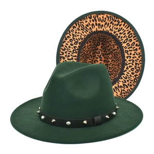Detail of dark green fedora hat featuring leopard print lining and studded leather band