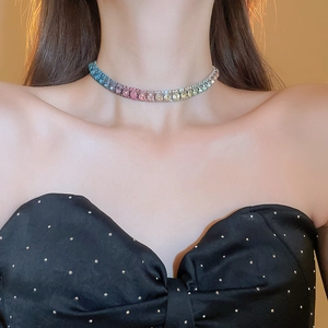Close-up of a colorful rhinestone choker necklace featuring a vibrant rainbow gradient effect
