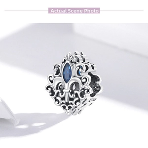 Macro detail of S925 silver hollow bead with blue marquise gemstone and hallmark