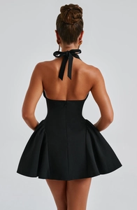 Back view of a sexy black halter neck dress with backless design and flared skirt