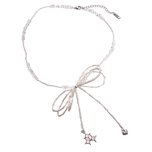 Silver beaded necklace with a bow, pink star charm and heart pendant on white background