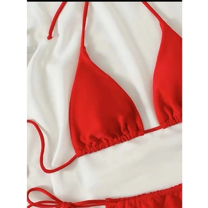 Close-up of vibrant red triangle bikini top with drawstring ties and ruched fabric texture