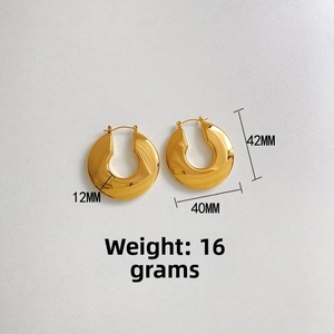 Detail view of large gold hollow U-shaped stainless steel earrings with 12mm thickness