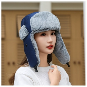 Close-up of winter trapper hat with windproof navy fabric and grey faux fur lining