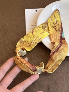 Detailed view of Van Gogh sunflower print headband with vintage gold beaded metal edge