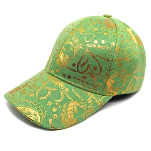 Green baseball cap with gold graffiti print featuring artistic heart and floral patterns