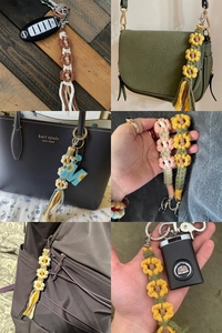 Detailed views of handmade woven flower keychains on car keys and designer handbags