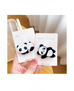 Detail of cute panda hair clips made of acetate fiber on a jewelry display card