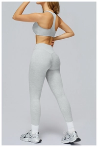 Close-up of grey mélange yoga set featuring racerback sports bra and high-waist leggings